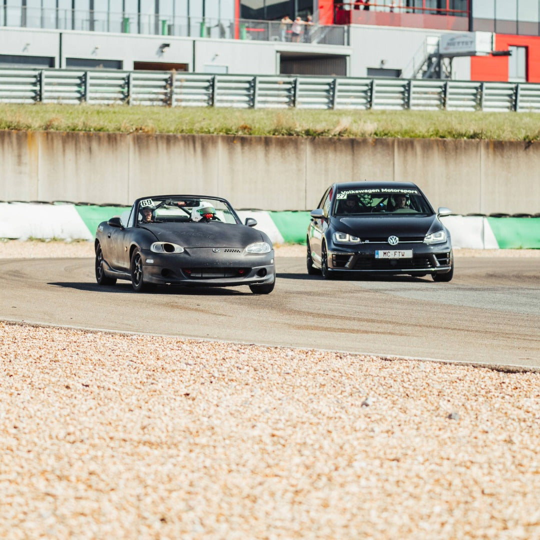 A Mazda MX5 and Golf GTI having fun during a GP Days Open Pitlane Track Day at Circuit Mettet